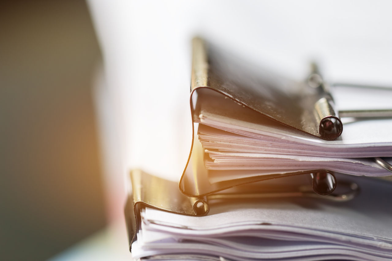 Stack of Paper documents with clip, Pile of unfinished documents on office desk folders. Business papers for Annual Report files, Document is written,presented. Business offices concept.