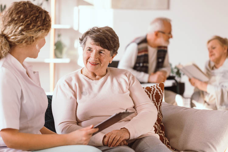 Senior caucasian woman talking with a nurse in the medical facility