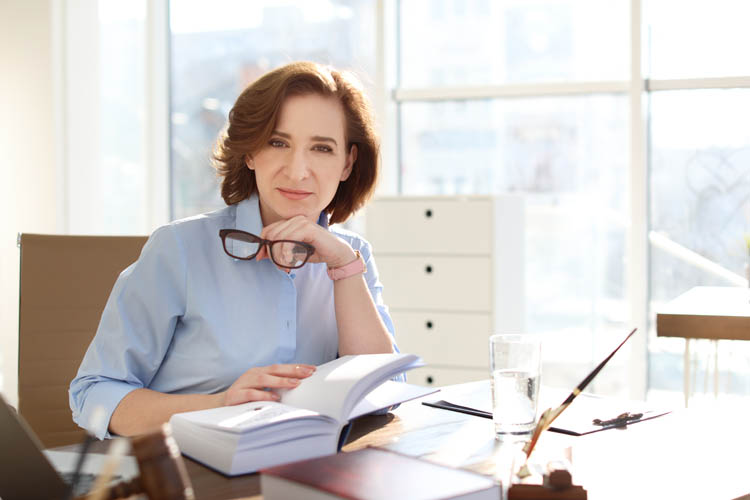 Female lawyer working at table in office